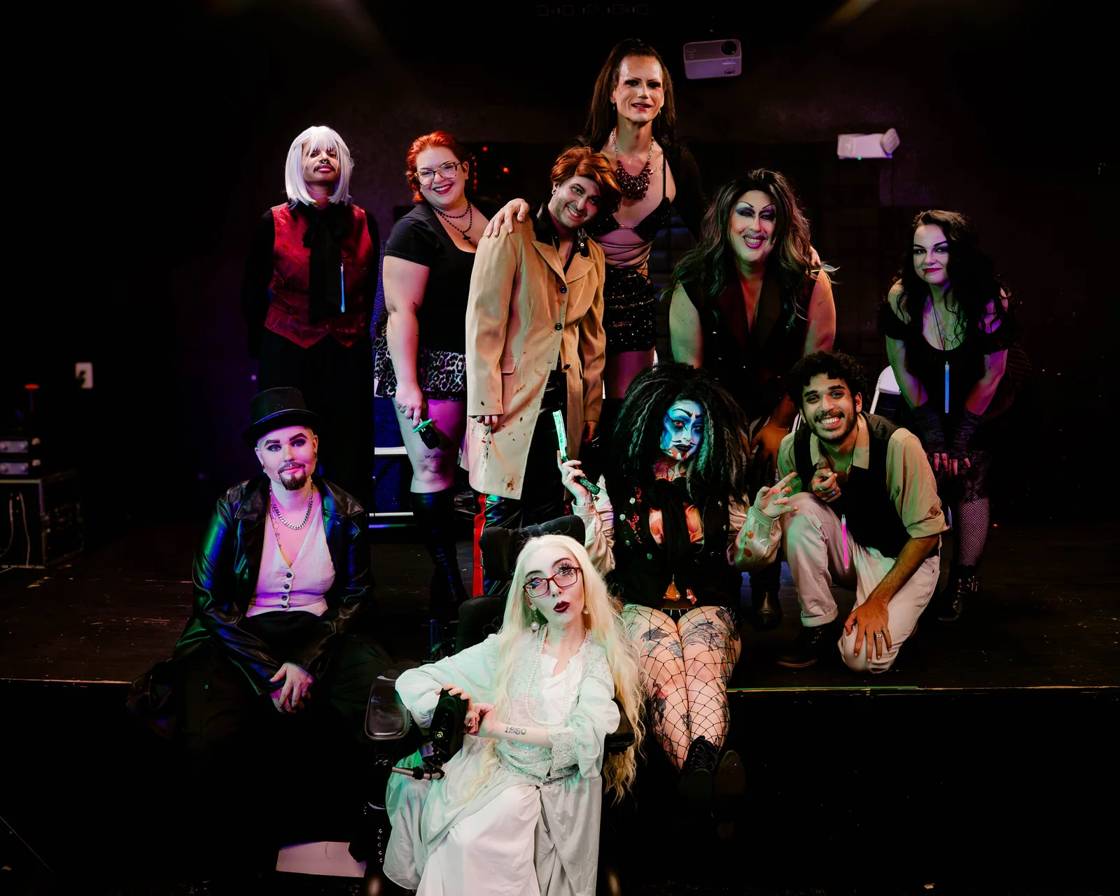 The Queen-y Todd cast gathered together on stage in costume.